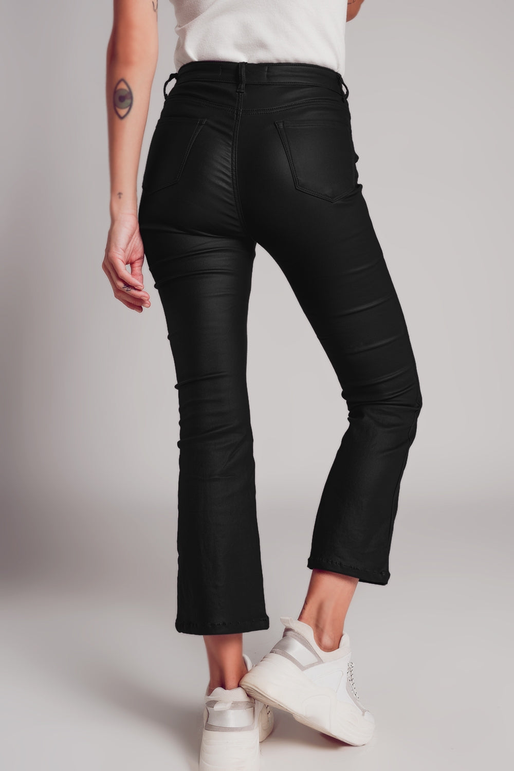 Stretch faux leather flare pants in black - trousers