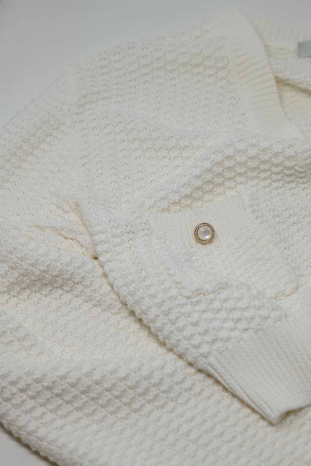 White long sleeve cardigan with button closure and front pockets