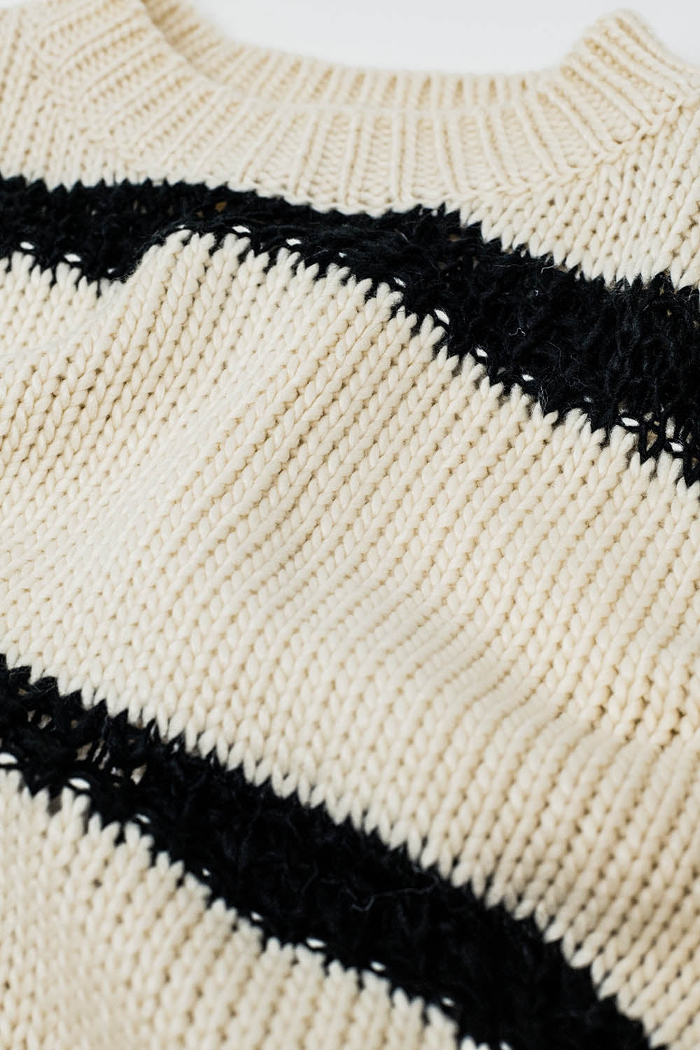 Relaxed beige jumper with black stripes