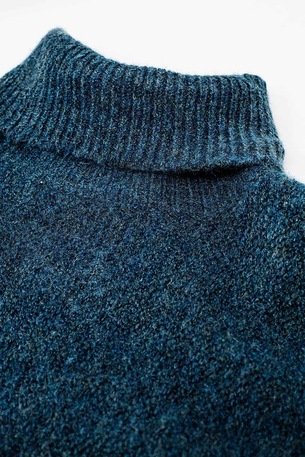 Oversized sweater in teal with a high neck and loose sleeves