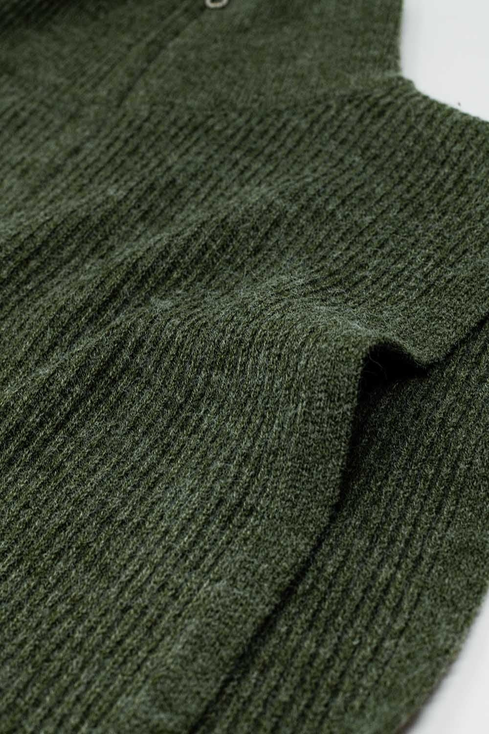 Green sleeveless turtleneck sweater with zipper closure