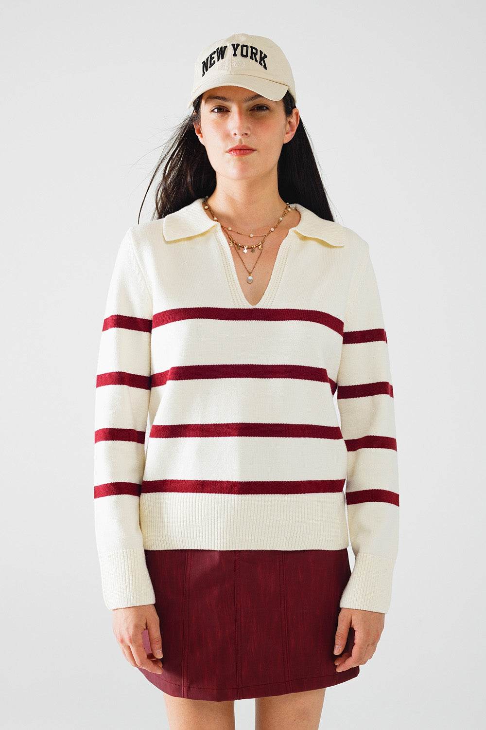 white sweater with dark red stripes and wide v neck