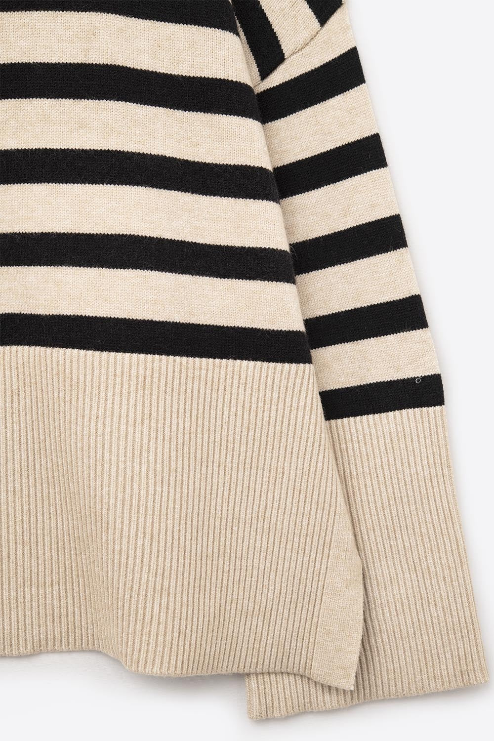Beige oversized turtleneck sweater with black stripes and splits on the side -