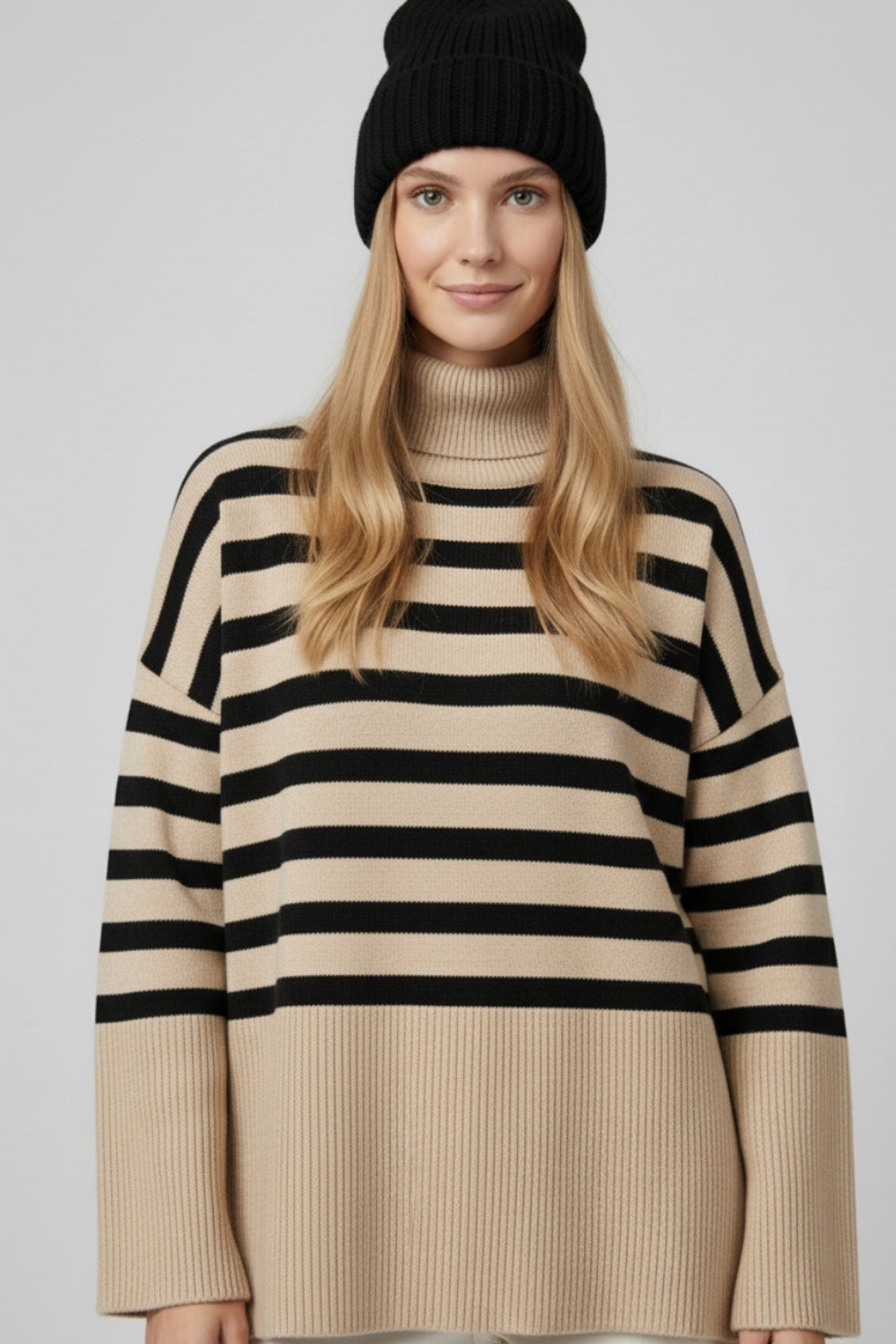 Beige oversized turtleneck sweater with black stripes and splits on the side -