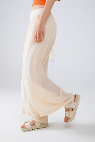 Pantalon beige style Palazzo avec poches latérales et ceinture épaisse