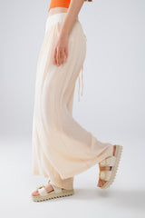 Pantalon beige style Palazzo avec poches latérales et ceinture épaisse