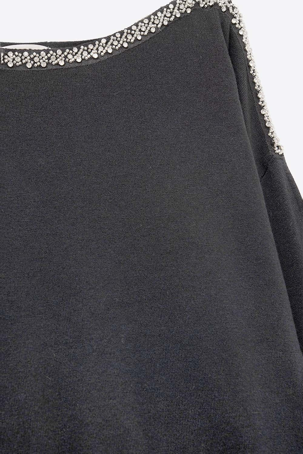 black fine knit sweater with a boat neck and rhinestone detail -