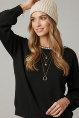 black fine knit sweater with a boat neck and rhinestone detail