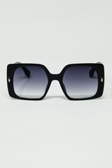 Black square sunglasses with gold detail on the side