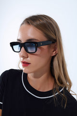 Black sunglasses with oval frame with gold detail and blue glass