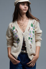 Cardigan bege de malha entrançada com flores bordadas