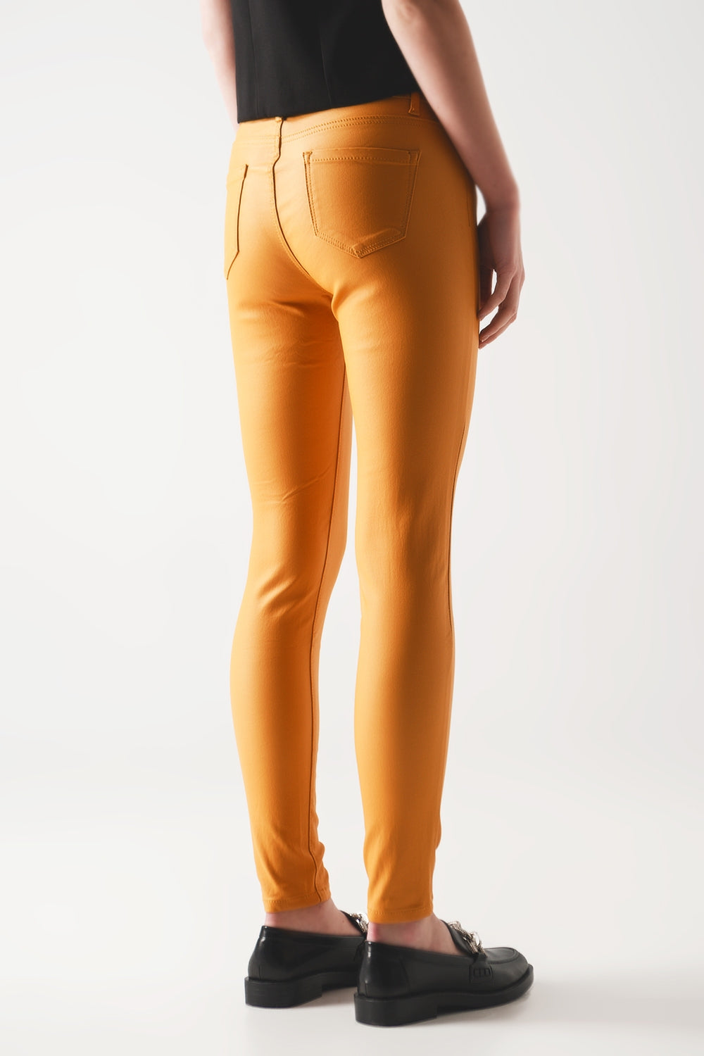 Coated pants in orange - Trousers