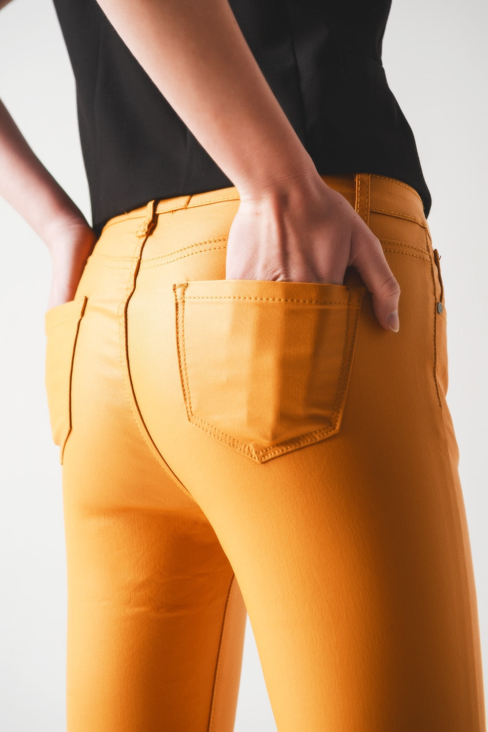Coated pants in orange - Trousers