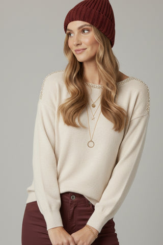 cream fine knit sweater with a boat neck and rhinestone detail