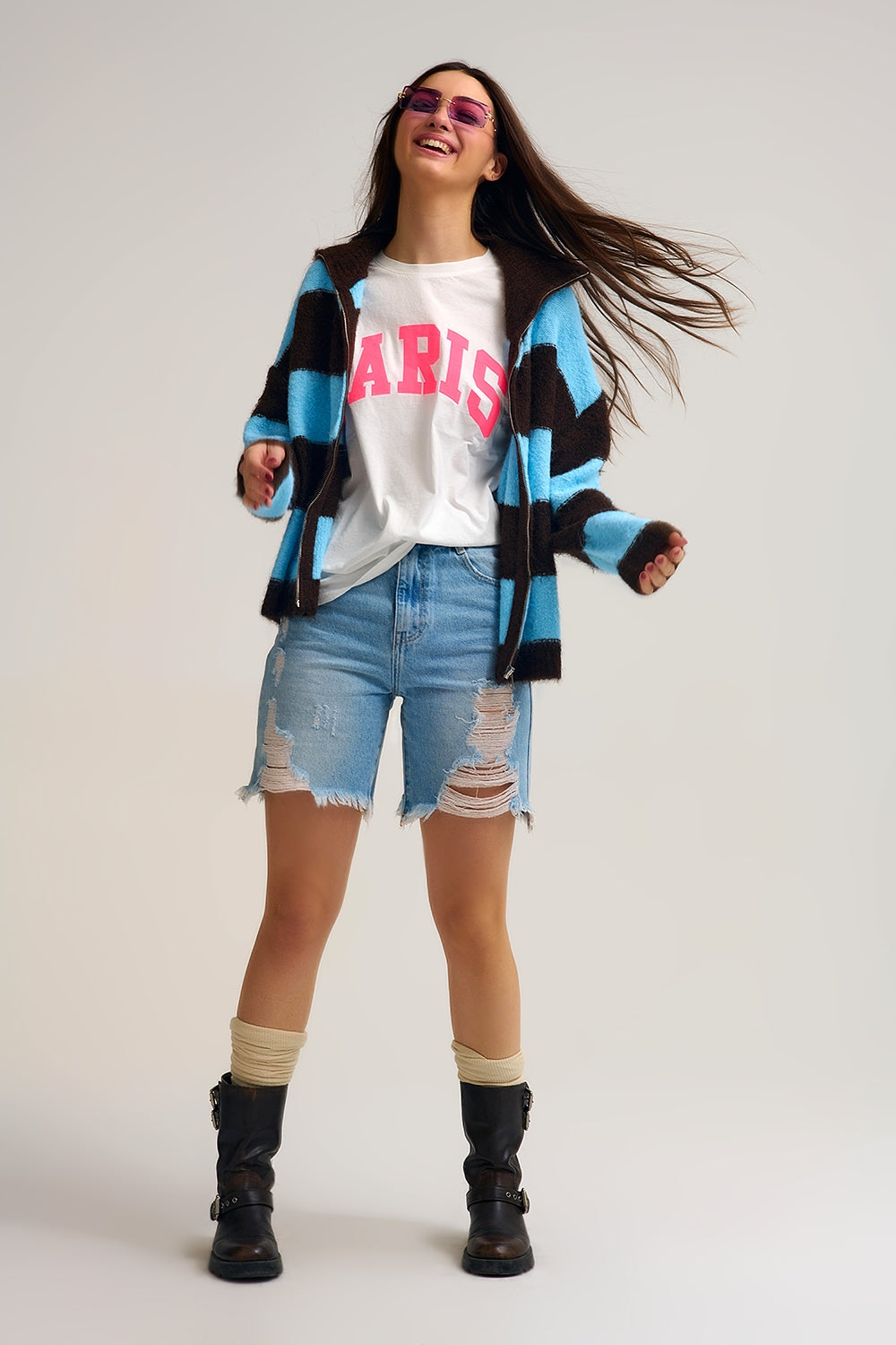 Model wearing a Fluffy Knitted Zip-Up Jacket over a t-shirt and distressed shorts, styled for a trendy look