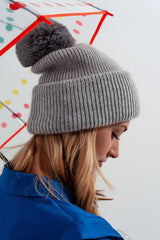 Gray knitted hat with pompom