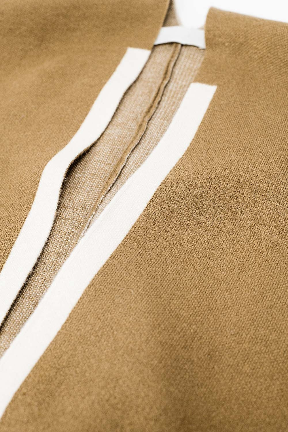 Knitted poncho in camel with ecru trim - Ponchos