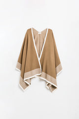 Knitted poncho in camel with ecru trim