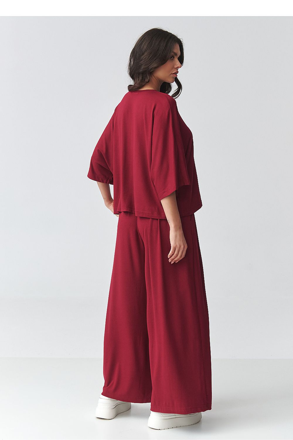 Makadamia outfit set featuring a loose-fitting blouse and wide-leg trousers in burgundy hue