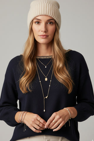 navy fine knit sweater with a boat neck and rhinestone detail