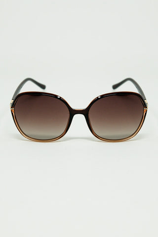 Round sunglasses in caramel color with gold metal detail