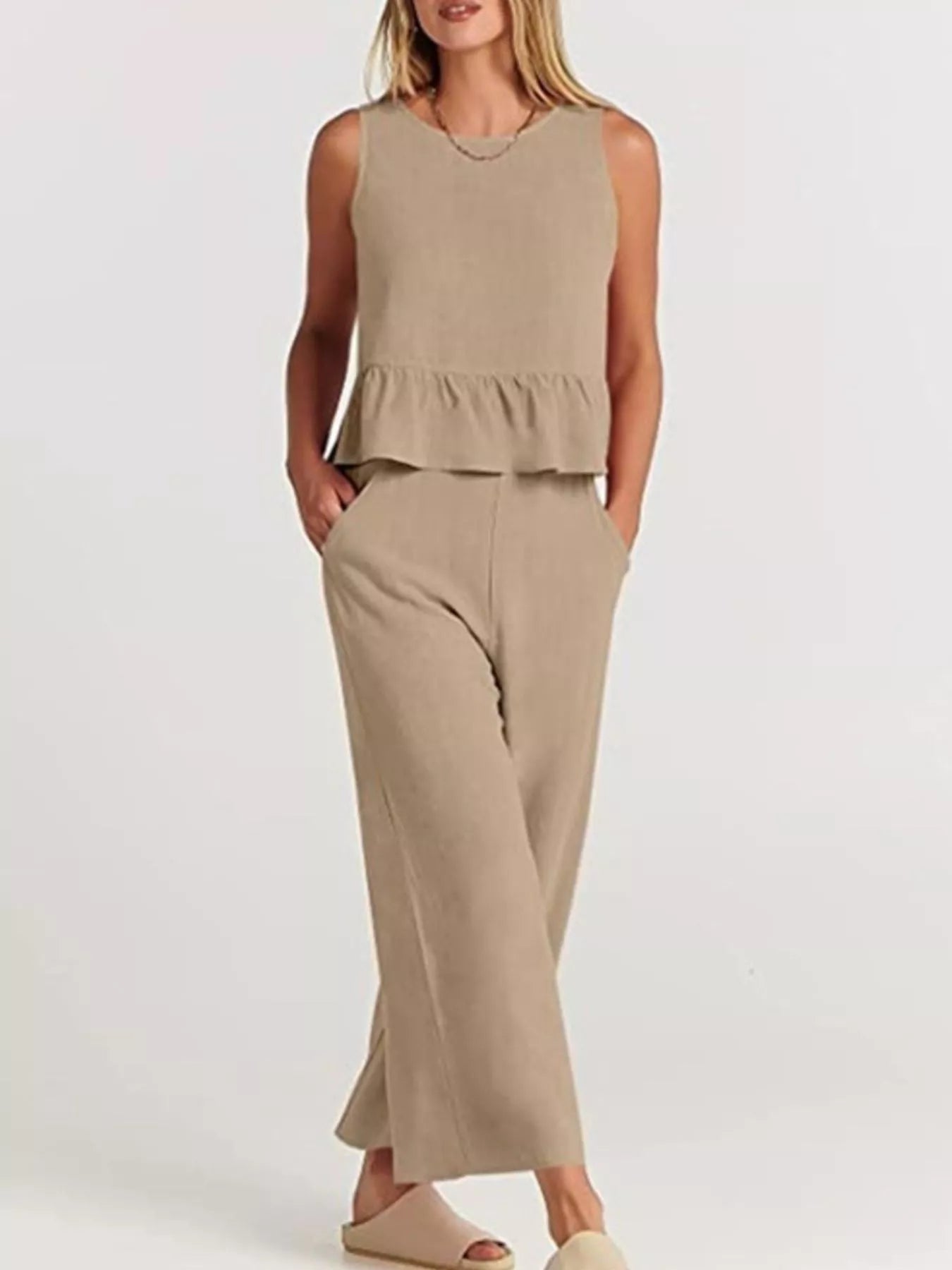 Trendsi plus size set featuring a sleeveless peplum top and wide-leg trousers in a neutral beige tone