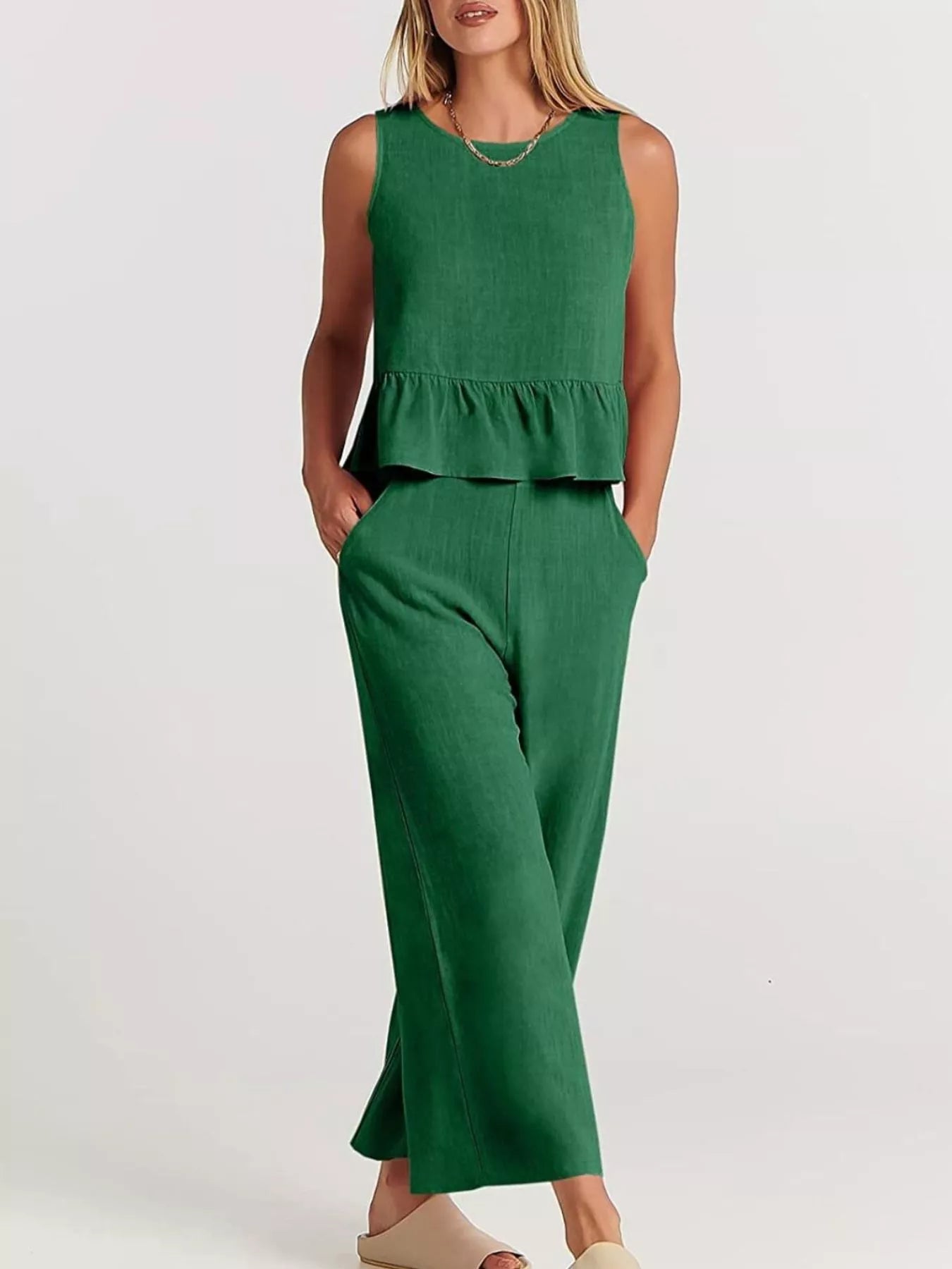 Trendsi set plus size in green featuring a sleeveless top with peplum design and wide-leg trousers