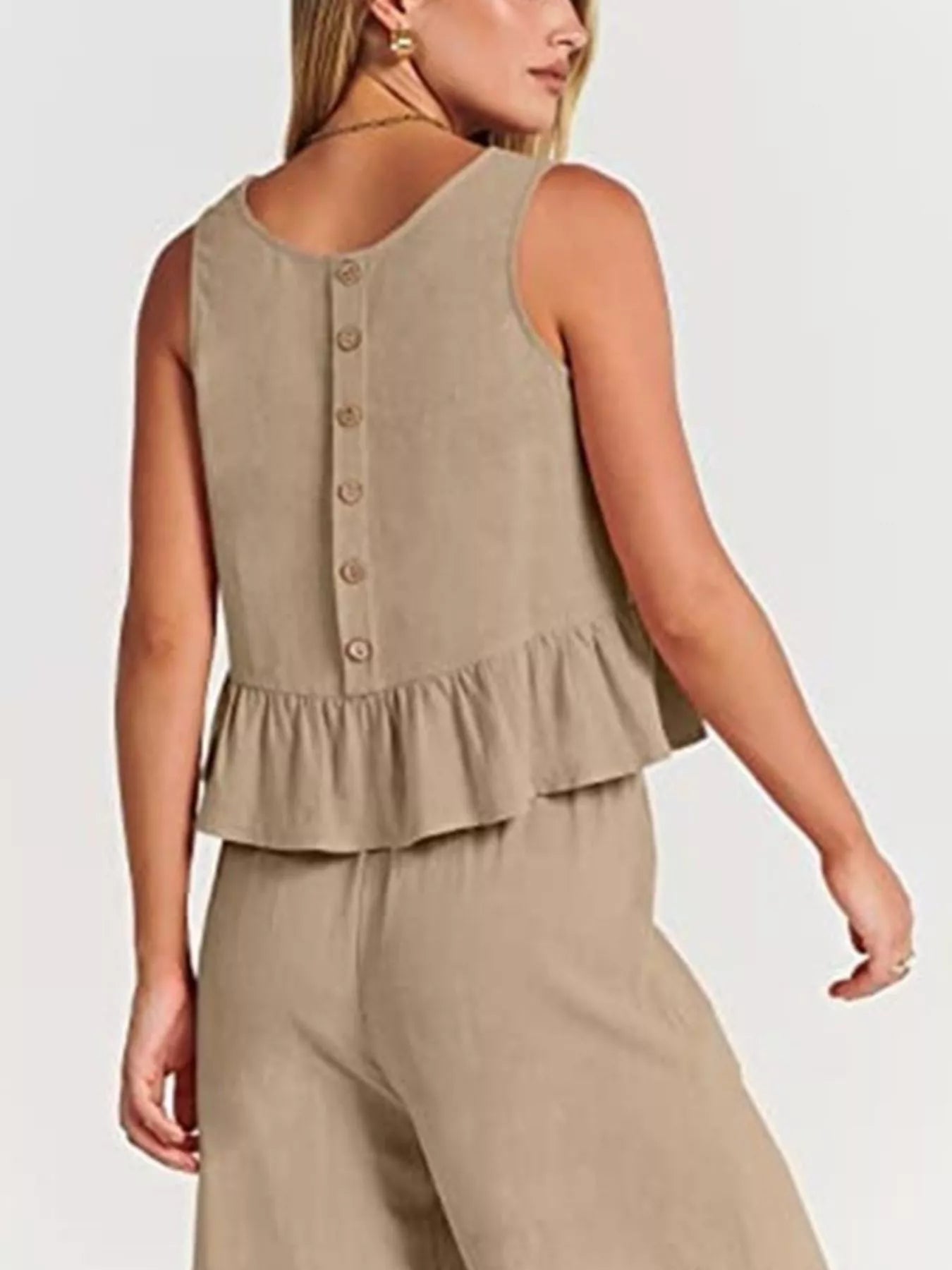 Plus size set with a beige peplum top featuring button detailing at the back