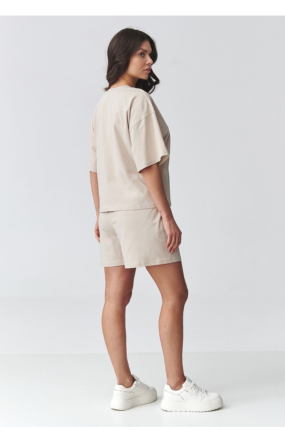 Beige Makadamia outfit set featuring a short sleeve blouse and matching shorts for a casual look
