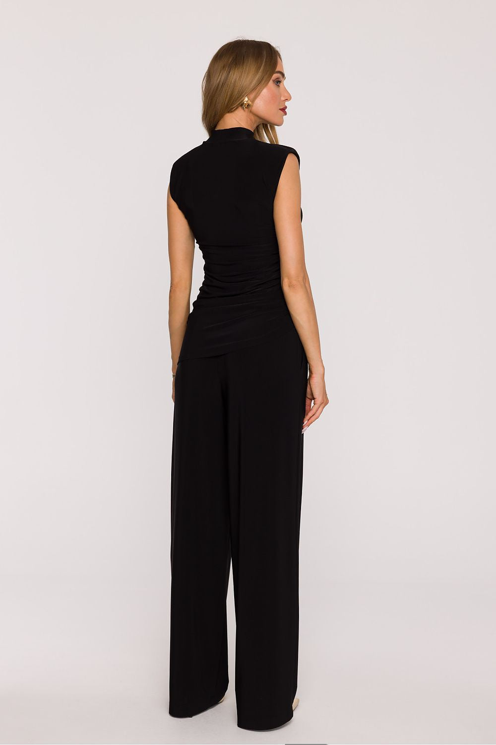 Back view of a women's outfit set in black made from smooth knit fabric set for a stylish look