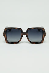 Sunglasses with a brown print frame and black temples