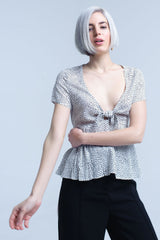 Haut à pois blancs avec ourlet à volants