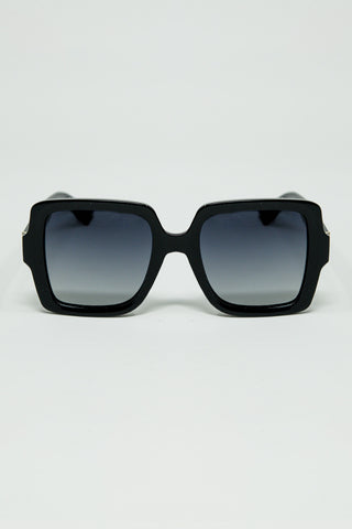 Wide square frame sunglasses with gold detail on the temples